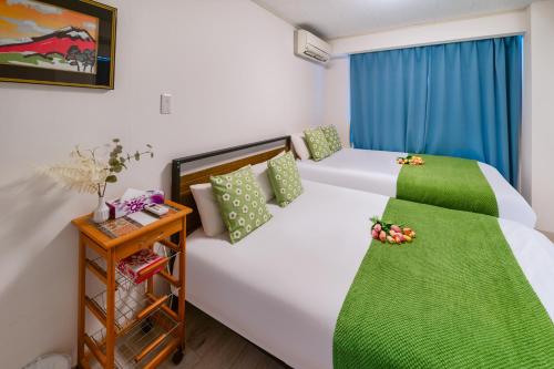 a bedroom with two beds and a night stand at 2 bedrooms and 1 living room on the 1st floor, 40sqm house, 10 min walk to Oji 2 min walk to Kajiyara Toden Arakawa Line in Wada