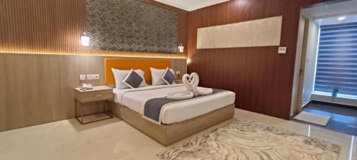 a bedroom with a bed and a bathroom with a window at Montecarlo Hotel in Mahabalipuram