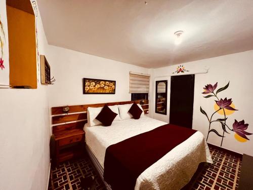 a bedroom with a large bed in a room at Balcon Plaza Villa de Leyva Hotel in Villa de Leyva
