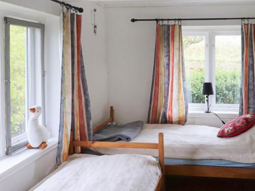 a bedroom with two bunk beds and a window at Panoramic Skanelanga Retreat-By Traum in Hammenhög