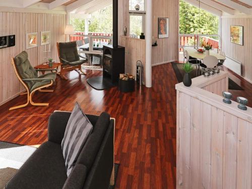a living room with a couch and a table at 6 person holiday home in Hadsund in Øster Hurup