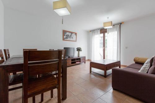a living room with a couch and a table at Alojamientos Botica Rural in La Cabrera