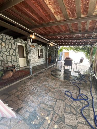 an outdoor patio with a stone floor and a table at LEO Home in Hrazdan