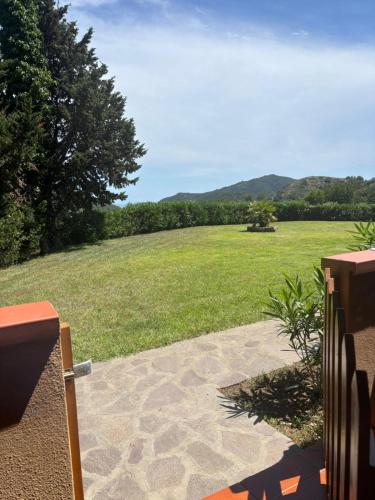 a view of a large field of grass with a gate at Casa dell'Acqua - Isola d'Elba in Rio nellʼElba