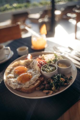 a plate of food with eggs and toast on a table at Mira Hotel and Recovery in Uluwatu