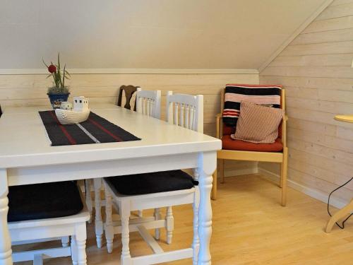 a dining room with a white table and chairs at 5 person holiday home in Fjällbacka in Fjällbacka