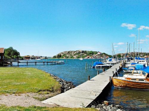 a group of boats docked at a dock at 5 person holiday home in Fjällbacka in Fjällbacka