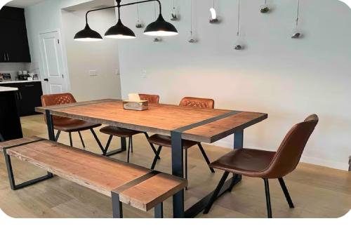 a dining room table with chairs and a bench at Affordable Cozy Bedroom Close to YYC Airport in Calgary