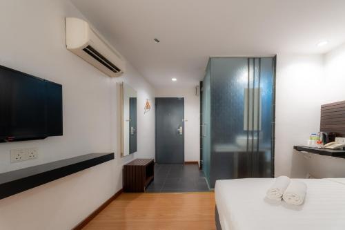 Ένα ή περισσότερα κρεβάτια σε δωμάτιο στο T+ Hotel Sungai Petani
