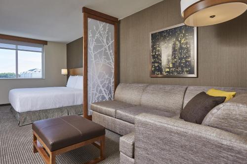 a living room with a couch and a bed at Hyatt Place Toronto Mississauga and Luxe Convention Centre in Mississauga