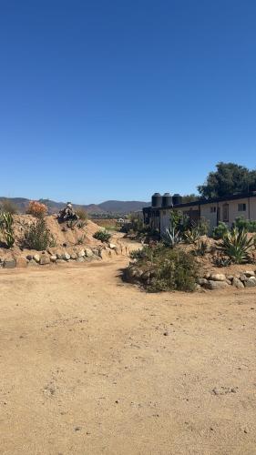 a train in the middle of a dirt field at Ranchito Boutique Motel Buhos Valle Guadalupe in Francisco Zarco