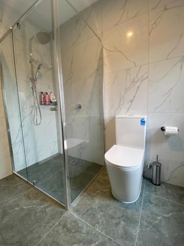 a bathroom with a shower and a toilet at Springvale 3 Bedroom Town House - Best Location in Springvale