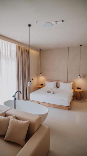 a hotel room with two beds and a couch at La Gaia - Adult Only in Alanya