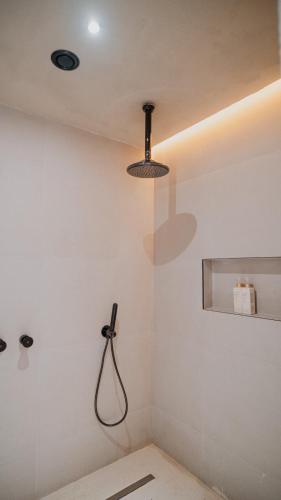 a shower in a bathroom with a light fixture at La Gaia - Adult Only in Alanya