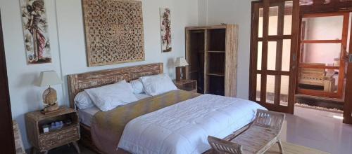 a bedroom with a large bed and a window at Padma Laya Private Villa 2BR in Sukawati