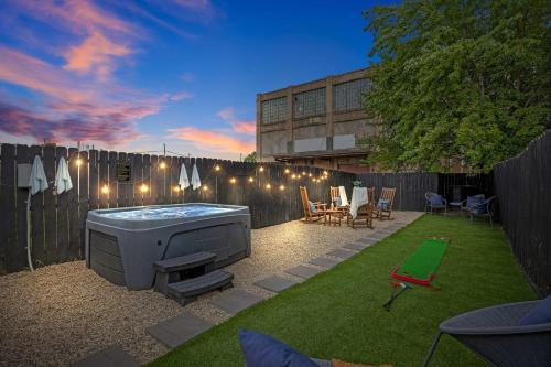 a backyard with a hot tub and a fence at Classic Louisville Home with Contemporary Upgrades in Louisville