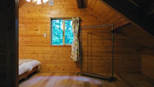 a small room with a bed and a window at Private Retreat Nagano Iizuna 