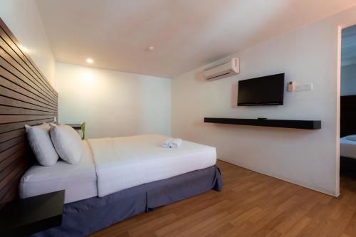 Ένα ή περισσότερα κρεβάτια σε δωμάτιο στο T+ Hotel Sungai Petani