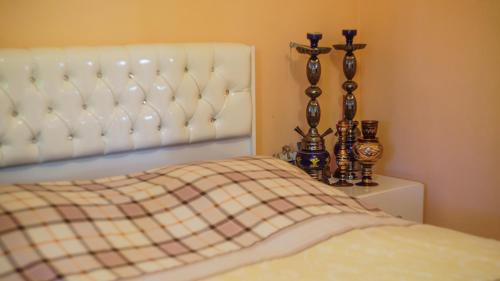 a bedroom with a bed with a plaid blanket at Nargiz's Guest House in Batumi
