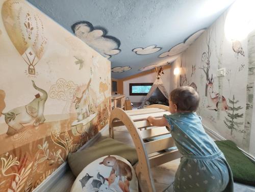 a young child playing in a room with a crib at Feel like Home - vista montagna, vicino lago di Como in Maggio
