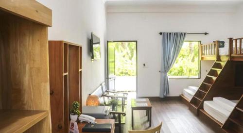 a living room with a staircase and a couch at HON BA LAGI BEACH RESORT in La Gi
