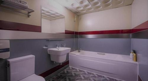 a bathroom with a white toilet and a sink at Hotel Head-One in Uijeongbu