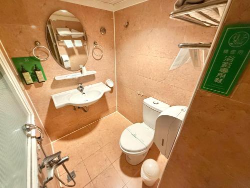 a small bathroom with a toilet and a sink at 種子商旅 in Kaohsiung