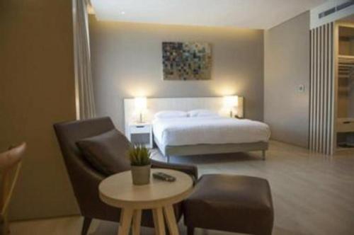 a hotel room with a bed and a table and chairs at Double G Resort Anyer in Carita