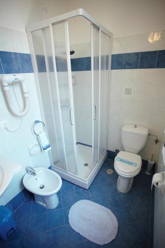 a bathroom with a shower and a toilet and a sink at Residenza Matilde in Rome