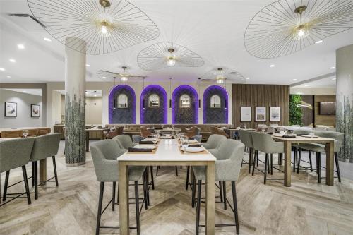 a rendering of a restaurant with tables and chairs at Hilton Garden Inn Nashville Opryland in Nashville