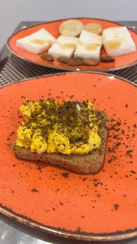 a plate with a piece of bread with mustard and cheese at Villa Yucca - B&B and Glamping in Torano Nuovo