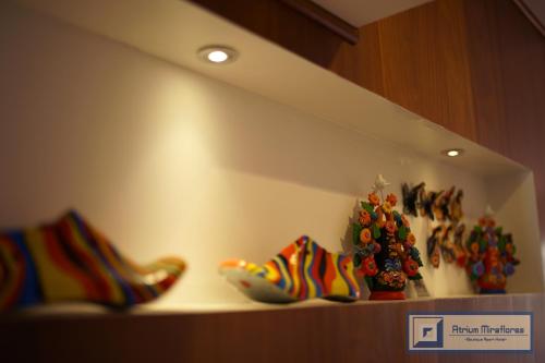 a shelf with three pairs of shoes and a christmas tree at Atrium Miraflores Hotel in Lima