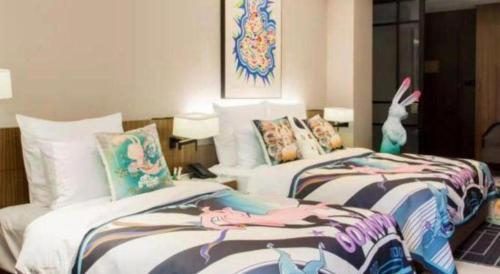a bedroom with two beds with mermaid pillows at Chongqing The Lotus Hotel in Chongqing