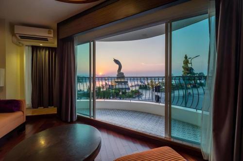 a living room with a view of a balcony at LANDMARK NAKHONPHANOM HOTEL in Nakhon Phanom