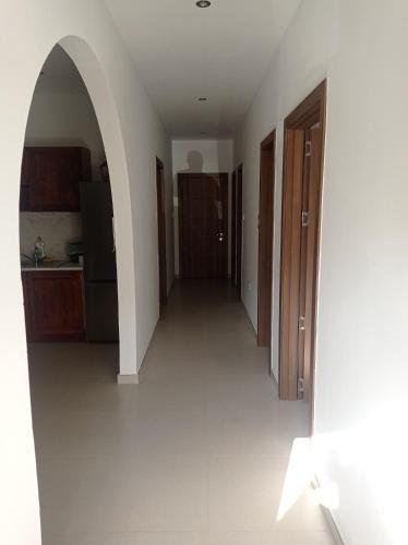 an empty hallway of a kitchen with an archway at Valletta Gateway Maisonette in Valletta