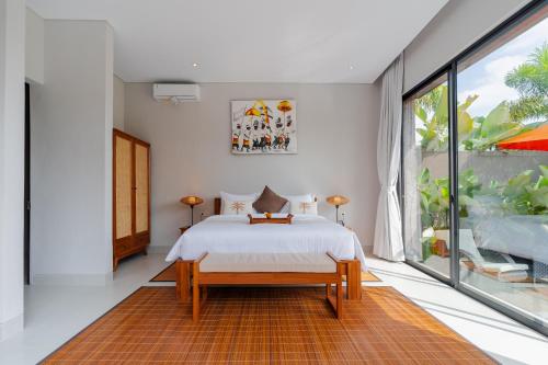 a bedroom with a bed and a large window at Sierra Vista 2 Ubud in Ubud