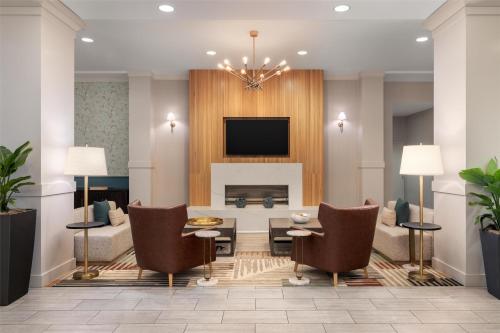a living room with a couch and a fireplace at Hilton Garden Inn Shirlington in Arlington