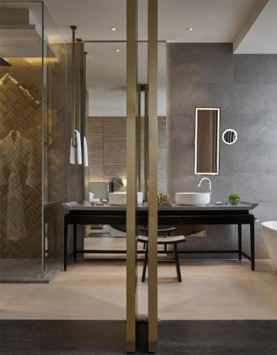 a bathroom with a black table and two sinks at Park Hyatt Kuala Lumpur in Kuala Lumpur