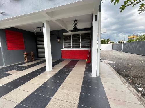 a building with a red door on a street at Ipoh Comfortable Rooms Only-Private Bathrooms Indoor Car Parking SY30 in Ipoh