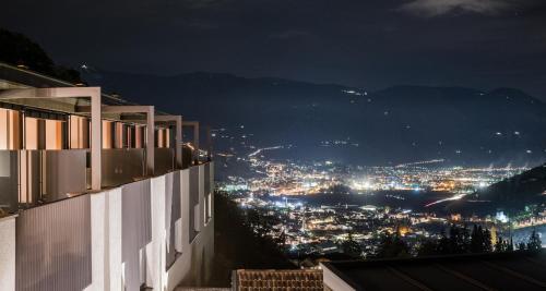 a view of a city at night at Paloria Apartments & Sport in Lagundo