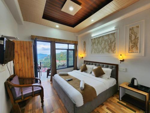 a bedroom with a bed and a chair and a television at Sirhind Regency - Budget Friendly !! Travellers Delight !! Luxury Rooms !! Best Awarded in Shimla