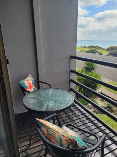 a patio with a table and chairs on a balcony at Accommodation Portland Victoria in Portland