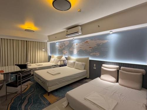 a hotel room with two beds and a large screen at Luxury Penthouse & High-Floor Hotel near City of Dreams, Airport, Okada, and Solaire Casino in Manila