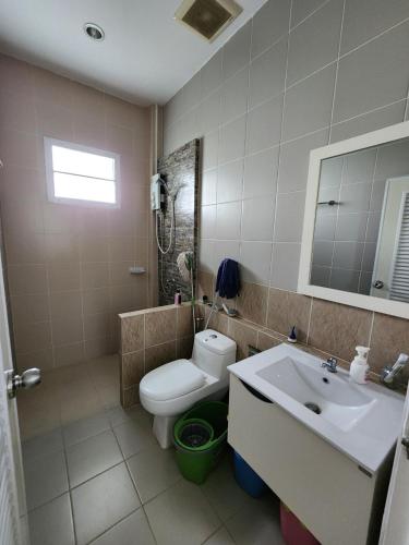 a bathroom with a toilet and a sink at Pleun City Village in Pran Buri
