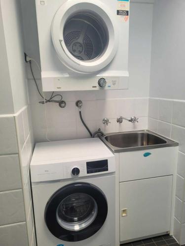 a washing machine and a sink in a small room at Accommodation Portland Victoria in Portland