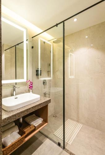 a bathroom with a sink and a shower at Effotel by Sayaji Panaji, Goa in Panaji