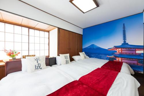 a bedroom with a large bed with a large window at 東京駅まで30分 日本の囲炉裏 1棟貸切 16名 130平米 2バスルーム パノラマビュー 桜 富士山 in Ichikawa