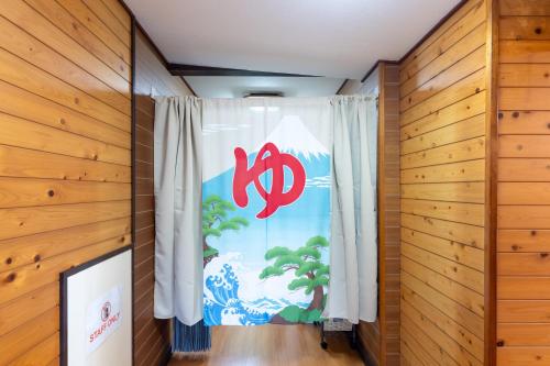 a window in a room with a curtain with the chinese symbol at 東京駅まで30分 日本の囲炉裏 1棟貸切 16名 130平米 2バスルーム パノラマビュー 桜 富士山 in Ichikawa