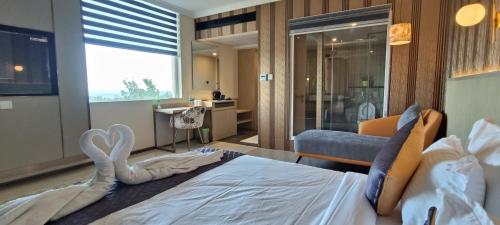 a bedroom with a bed with a swan on it at Montecarlo Hotel in Mahabalipuram