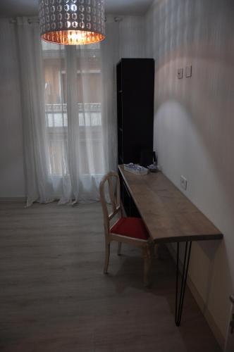 a dining room table with a chair and a chandelier at B&B la cruna deLago in Omegna
